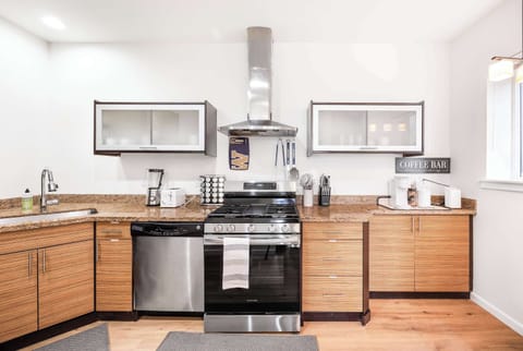 A well-designed, efficient kitchen with modern appliances and organized cabinetry for easy storage. The layout maximizes space and functionality, creating an ideal area for cooking and daily tasks, with everything within reach for seamless meal preparation.