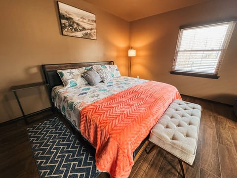 Primary bedroom with attached half bath and laundry.