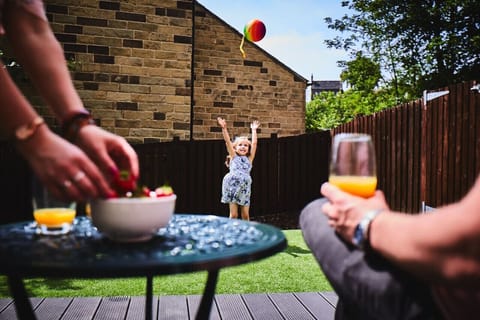 Patio doors lead to a decked area with lawned private garden