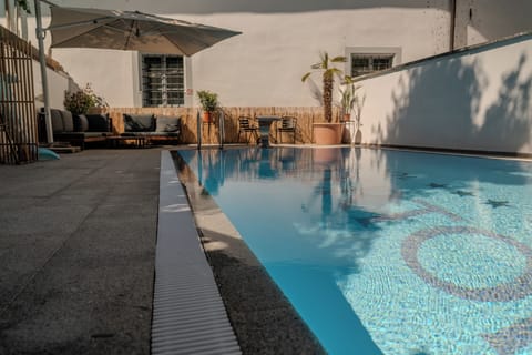 Outdoor pool, open 10:00 AM to 9:00 PM, pool umbrellas