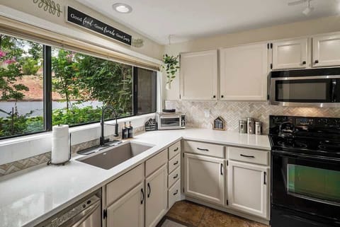 Bright, fully equipped kitchen with plenty of counter space—start your day right.