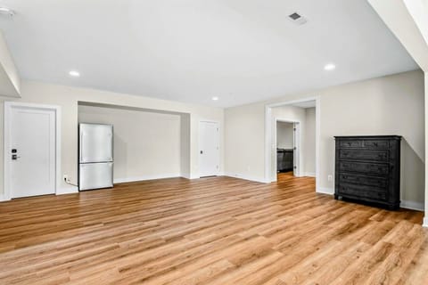 Game Room – A versatile space featuring sleek flooring, extra storage, a second refrigerator, a ping-pong table, and an arcade game, perfect for fun and relaxing.