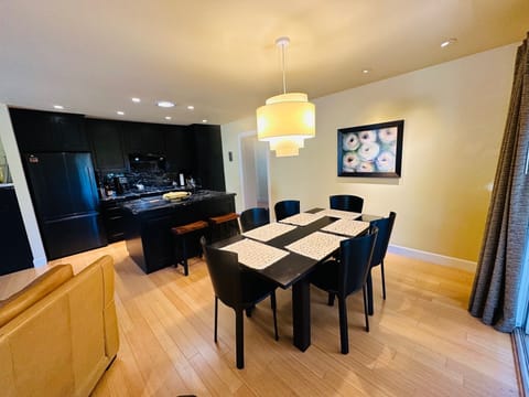 The dining area is located between the kitchen and door to the patio.