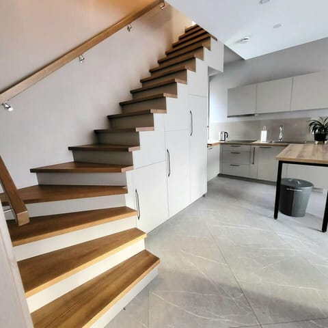 Modern Open-Plan Kitchen with Elegant Staircase Design