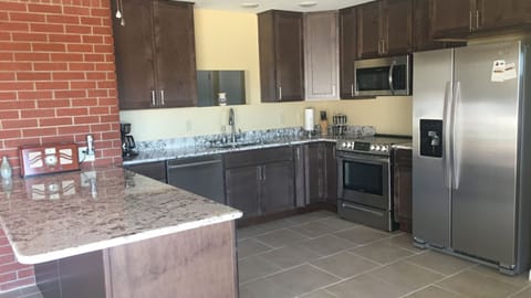 Kitchen fully stocked with utensils. New refrigerator...has breakfast bar.