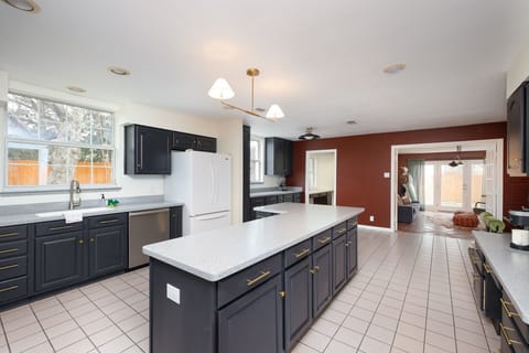 Features ample cabinetry, high-end appliances, and a spacious island—perfect for cooking, dining, and gathering. 