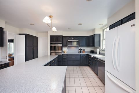 Features ample cabinetry, high-end appliances, and a spacious island—perfect for cooking, dining, and gathering. 