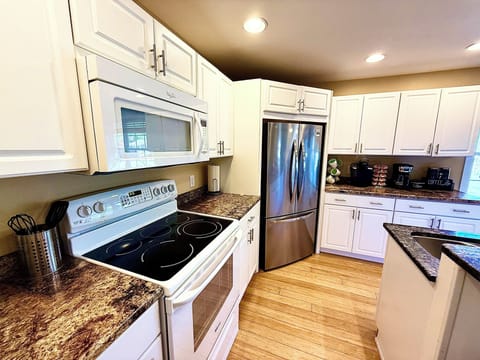 Everything you need for easy meal prep with a full stove, microwave, and spacious fridge ready for your groceries and late-night cravings.