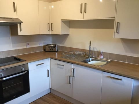 kitchen with oven, dishwasher, washing machine, toaster, micro wave, kettle