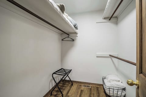 A spacious walk-in closet with plenty of storage, extra linens, and a luggage rack for added convenience.