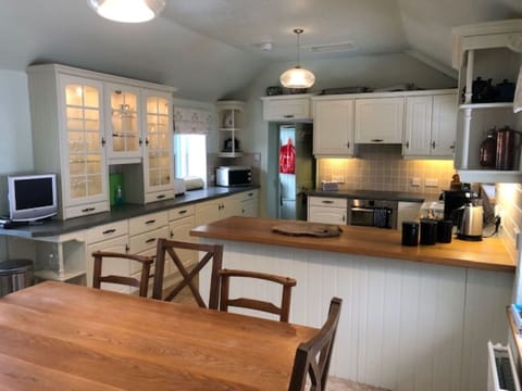 Furniture, Countertop, Cabinetry, Flooring, Kitchen, Interior Design, Kitchen Appliance, Wood, Light Fixture, Ceiling