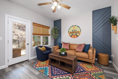 Welcome to your vibrant home base! Feat. a comfy leather sofa and 65" Smart TV