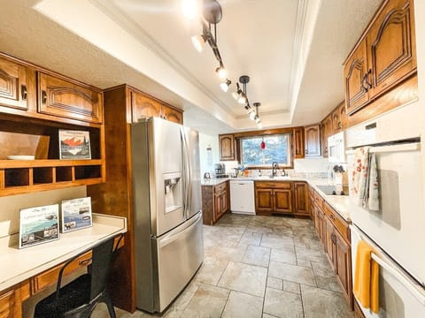 The fully-equipped kitchen features granite countertops, stainless steel appliances and ample space to prepare group meals.