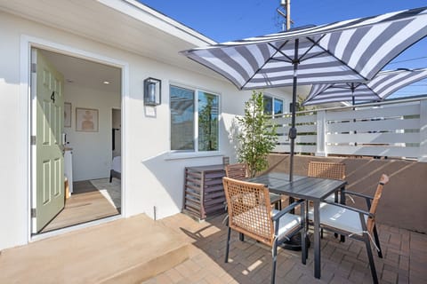 Enjoy your semi-private patio, featuring a table and umbrella, where you can relax and embrace the refreshing ocean breeze.
