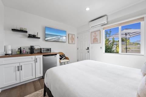 This modern, well equipped kitchenette with a small fridge, microwave, toaster oven/air fryer combo, and Keurig coffee maker -perfect for effortless meals and morning coffee.