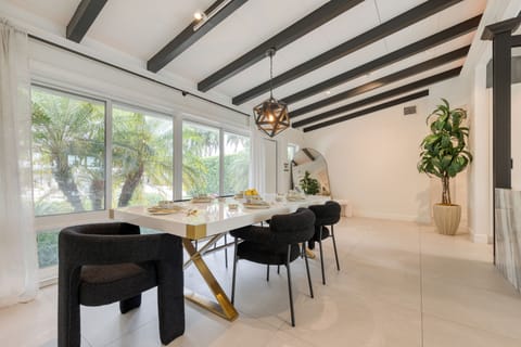 The dining area overlooks the pool, offering a relaxing and scenic backdrop for every gathering.