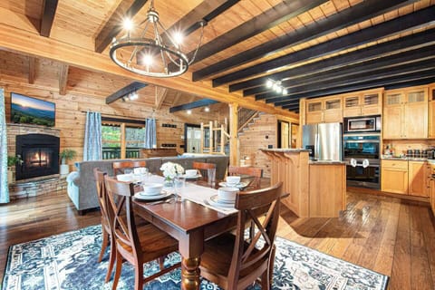 Enjoy meals in style in this cozy mountain cabin with a full kitchen, spacious dining area, and fireside living room—all in one beautifully rustic setting