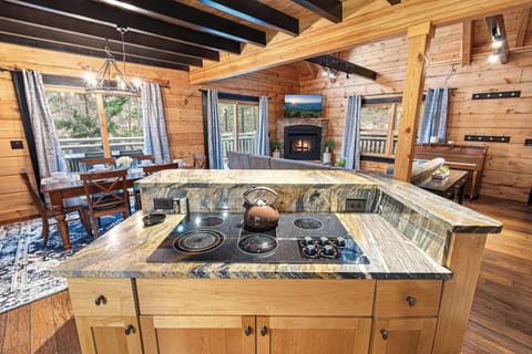 Whether you’re brewing morning tea or cooking dinner, enjoy panoramic windows, a crackling fire, and rustic elegance.