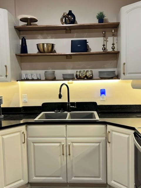 Fully equipped kitchen with stainless steel appliances and granite countertops.