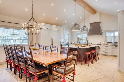 Large, open kitchen with plenty of seating at the tables and island.