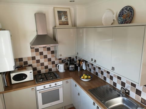 Kitchen with sink, cooker, cooker hood, microwave