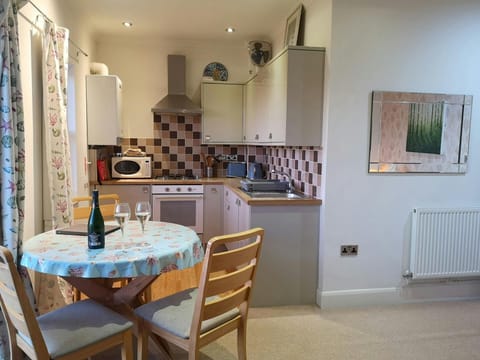 Dining area and kitchen with round table and chairs