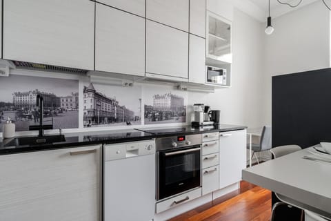 The kitchen is fully equipped with all the necessary appliances for a convenient stay.