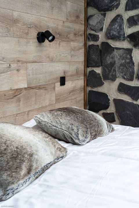 Every detail has been chosen for your comfort, from the plush pillows to the luxurious linens. The unique blend of modern design and natural stone and wood textures creates a peaceful and inviting sleeping environment.