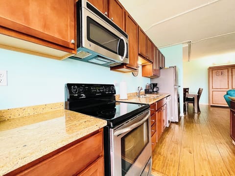 This well-appointed kitchen boasts granite countertops, a full-size refrigerator, and all the essentials for home-cooked meals. Whether making coffee or a gourmet dinner, it’s all at your fingertips.