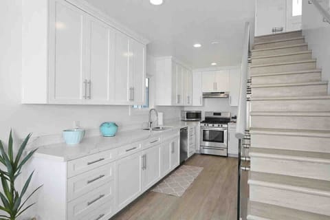 `Fully stocked kitchen with modern appliances, spacious dining table, and everything needed for family meals.`