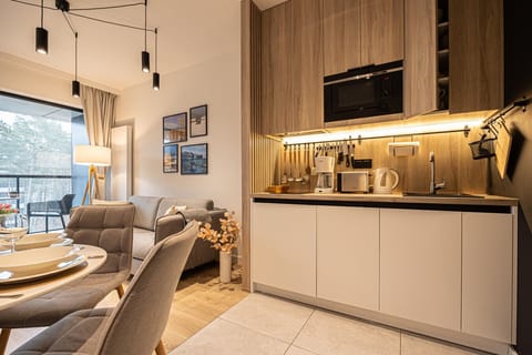 A modern kitchenette equipped with everything you need for a perfect seaside stay. Complete convenience and functionality at your fingertips.