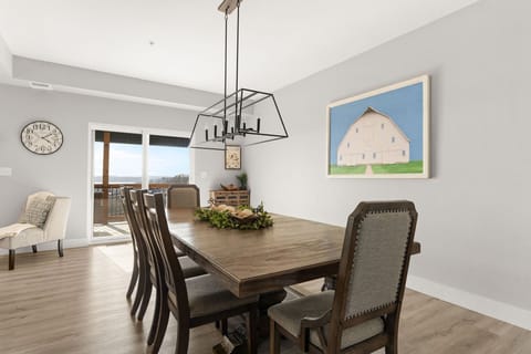 - Gather around the large rustic dining table for family meals or game night
- Charming decor and statement lighting set a warm, inviting scene
- Easy access to the deck makes outdoor dining a breeze