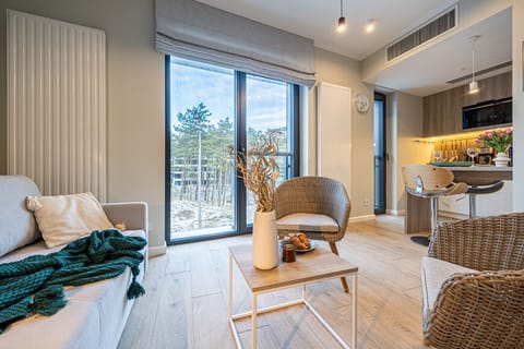 Spacious apartment with forest and sea views – Large windows and natural materials bring the beauty of nature indoors.