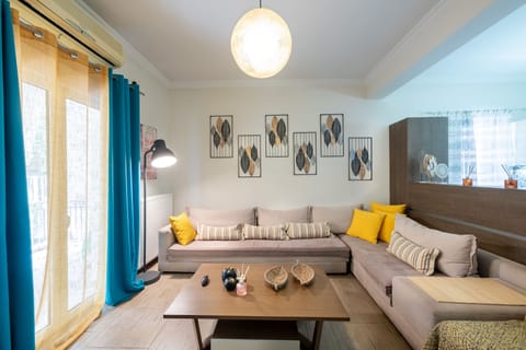 A spacious and comfortable living room with a huge couch and a smart TV.