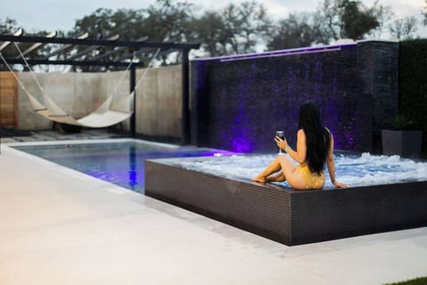 Relaxing water wall and infinity edge hot tub
