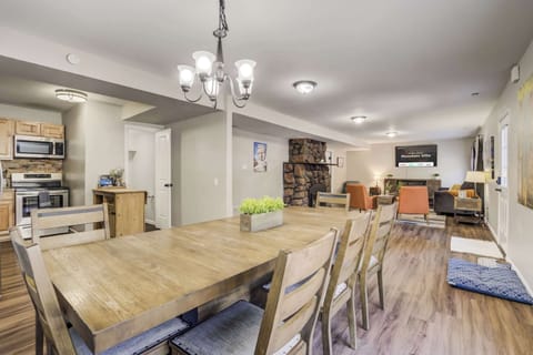 The open-concept dining area seamlessly connects to the kitchen and living room, creating a perfect setting for gatherings. The spacious wooden table comfortably seats eight, making it ideal for family meals, game nights, or casual conversations.