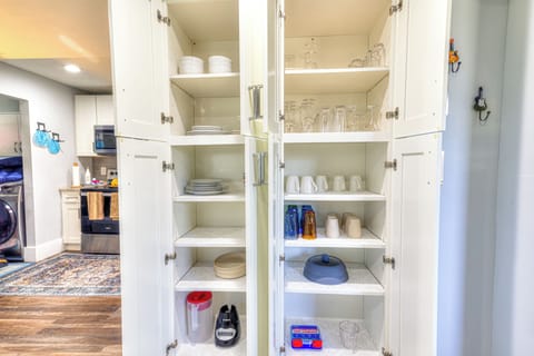 Glassware and dinnerware tucked inside kitchen cupboard