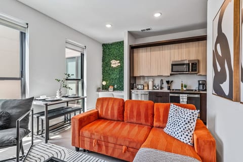 Modern open-concept living with cozy seating and a full kitchen 🍊