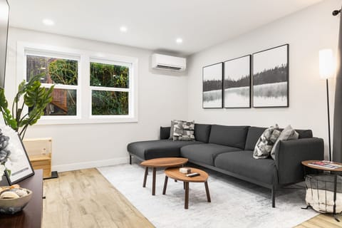 Bright living area with windows on two sides. Stretch out or catch up on a show.