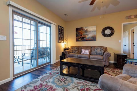 Comfortable living room featuring a sleeper sofa and direct access to a private deck—perfect for relaxation and additional guest accommodations.