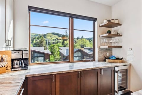 Open Concept Kitchen with Beautiful Designer Finishes, Wine Fridge, Bar Seating and Stunning Mountain Views