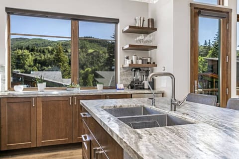 Open Concept Kitchen with Beautiful Designer Finishes, Wine Fridge, Bar Seating and Stunning Mountain Views