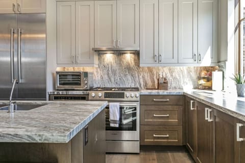 Open Concept Kitchen with Beautiful Designer Finishes, Wine Fridge, Bar Seating and Stunning Mountain Views