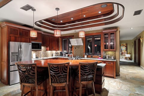 Entertain effortlessly in the spacious kitchen with premium appliances and island bar seating.