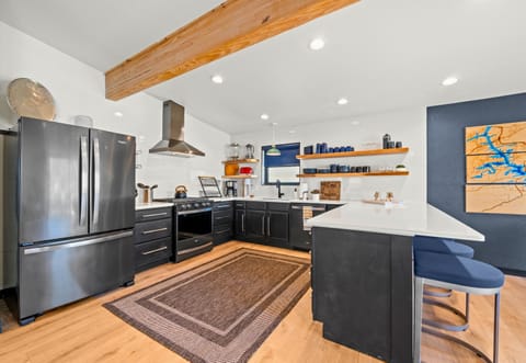 The spacious island serves as a central hub for cooking, snacking, and planning your next adventure by the lake.