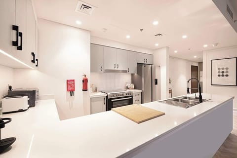 Bright and spacious kitchen with plenty of counter space, perfect for preparing meals comfortably during your stay.