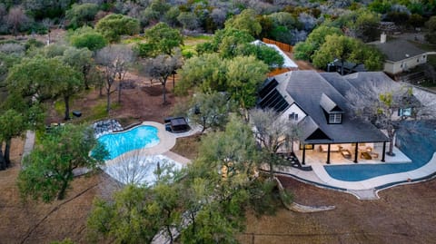 nestled among the trees, boasting a sparkling pool with a waterfall and a welcoming porch, offering a tranquil escape