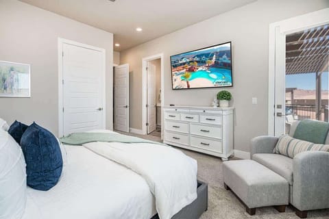 #52 - Master bedroom #2 upstairs with TV, chair and balcony with