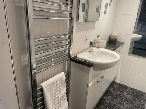 Shower, designer toiletries, hair dryer, towels