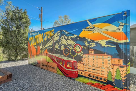 Vibrant Local Art! This colorful mural welcomes you to Colorado Springs, capturing iconic landmarks like Garden of the Gods and Pikes Peak. A perfect spot for photos and memories